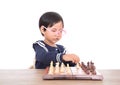 Chinese little girl with glasses frame playing chess seriously Royalty Free Stock Photo