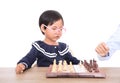 Chinese little girl with glasses frame playing chess seriously Royalty Free Stock Photo