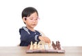 Chinese little girl with glasses frame playing chess seriously Royalty Free Stock Photo