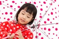 Chinese Little Girl Holding umbrella with raincoat Royalty Free Stock Photo