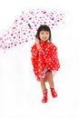 Chinese Little Girl Holding umbrella with raincoat Royalty Free Stock Photo