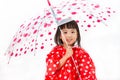 Chinese Little Girl Holding umbrella with raincoat Royalty Free Stock Photo