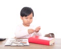 Chinese little girl between knowledge and money Royalty Free Stock Photo