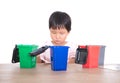 Chinese little girl learns tips on garbage classification according to the garbage bin model Royalty Free Stock Photo