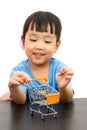 Chinese little girl pushing a toy shopping cart Royalty Free Stock Photo