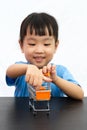 Chinese little girl pushing a toy shopping cart Royalty Free Stock Photo