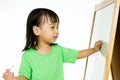 Chinese little girl writing on whiteboard Royalty Free Stock Photo