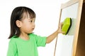 Chinese little girl writing on whiteboard Royalty Free Stock Photo