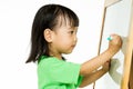 Chinese little girl writing on whiteboard Royalty Free Stock Photo