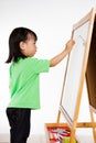 Chinese little girl writing on whiteboard Royalty Free Stock Photo