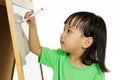 Chinese little girl writing on whiteboard Royalty Free Stock Photo