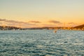 Chinese male tourist on a cruise ship enjoying the view of seascape at the Bosphorus strait and the sunset in Istanbul, vacation Royalty Free Stock Photo