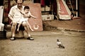 Chinese man carries a child who is excited by a bird