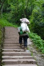 Chinese man carry goods in the mountains Royalty Free Stock Photo