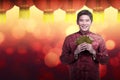 Chinese man in cheongsam suit holding angpao Royalty Free Stock Photo