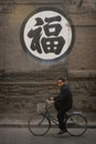 Chinese man riding a bike