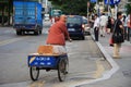 Chinese man riding a bike selling traditional cake