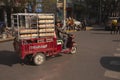 Chinese man riding a cargo moped loaded with bread from a baker in a street in China. Cargo bikes or freight mopeds are popular tr