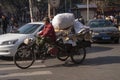 Chinese man riding a cargo tricycle loaded with goods in a street in Beijing, China. Cargo bikes or freight tricycles are popular