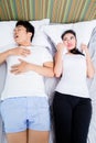 Chinese man snoring keeping his wife awake Royalty Free Stock Photo