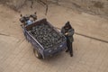 Chinese man standing by a 3 wheel motorcycle carrying coal in the ancient city of Pingyao. Top view seen from above. Royalty Free Stock Photo