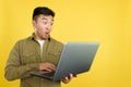 Chinese man with a surprised look using a laptop Royalty Free Stock Photo