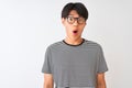 Chinese man wearing glasses and navy striped t-shirt standing over isolated white background afraid and shocked with surprise Royalty Free Stock Photo