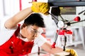 Chinese man working with drill in factory Royalty Free Stock Photo