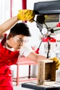 Chinese man working with drill in factory Royalty Free Stock Photo