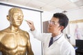 Chinese medicine doctor teaching acupoint on human model