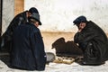 Chinese men play Mahjong game open air on a market of Xining city