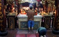 Chinese men praying inside a temple