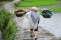 Chinese Miao nationality farmer in the rain Royalty Free Stock Photo