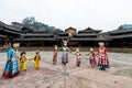 The Chinese miao women and kids wearing traditional clothes and dancing in open opera house of Xijiang Qianhu Miao Village One