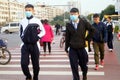 Chinese middle school students cross the road and wear masks
