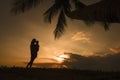 Mom holding little daughter in arms, watching sunset