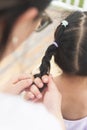 Chinese mom weave plaits for daughter