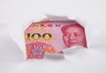 Chinese money behind hole in paper Royalty Free Stock Photo