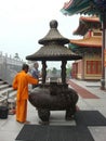 Chinese monk and big joss sticks pot Royalty Free Stock Photo