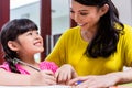 Chinese mother homeschooling her child Royalty Free Stock Photo