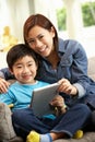 Chinese Mother And Son Using Tablet Computer