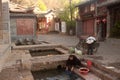 Chinese Naxi woman washing on ancient pool is White horse Dragon.