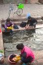 Chinese Naxi woman washing on ancient pool is White horse Dragon.