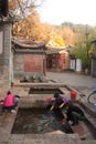 Chinese Naxi woman washing on ancient pool is White horse Dragon.