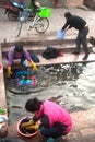 Chinese Naxi woman washing on ancient pool is White horse Dragon.