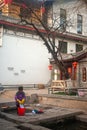 Chinese Naxi woman washing on ancient pool is White horse Dragon.