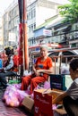 Old Thai Chinese lady selling pears for Chinese New Year along Yaowarat Road Bangkok