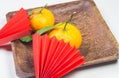 Chinese New Year, composition with mandarins, paper red origami fans on a dark wooden plate on a white background