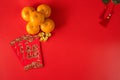 chinese new year concept with red envelope orange and gold on red background(non english text is GONG XI FA CAI