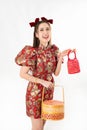 Chinese New Year concept, Woman holding a basket of food and red basket ,meaning to be happy healthy and wealthy year, Chinese New